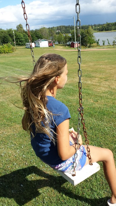 Girls swinging on a swing